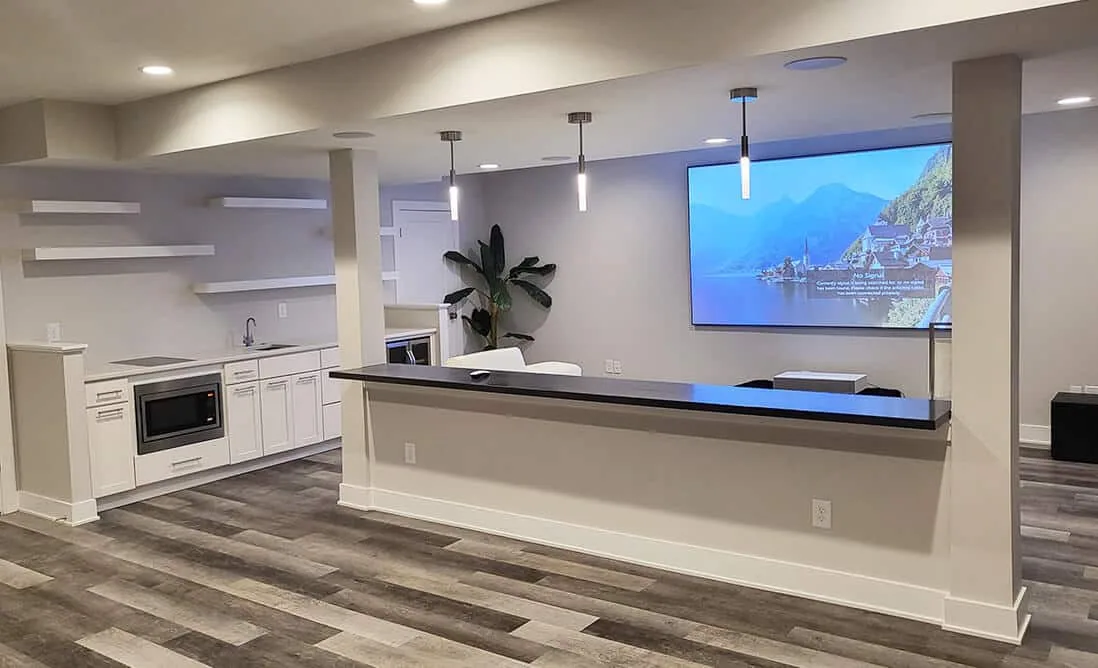 Basement wet bar and projector screen in a finished media room near Lawrenceville, GA
