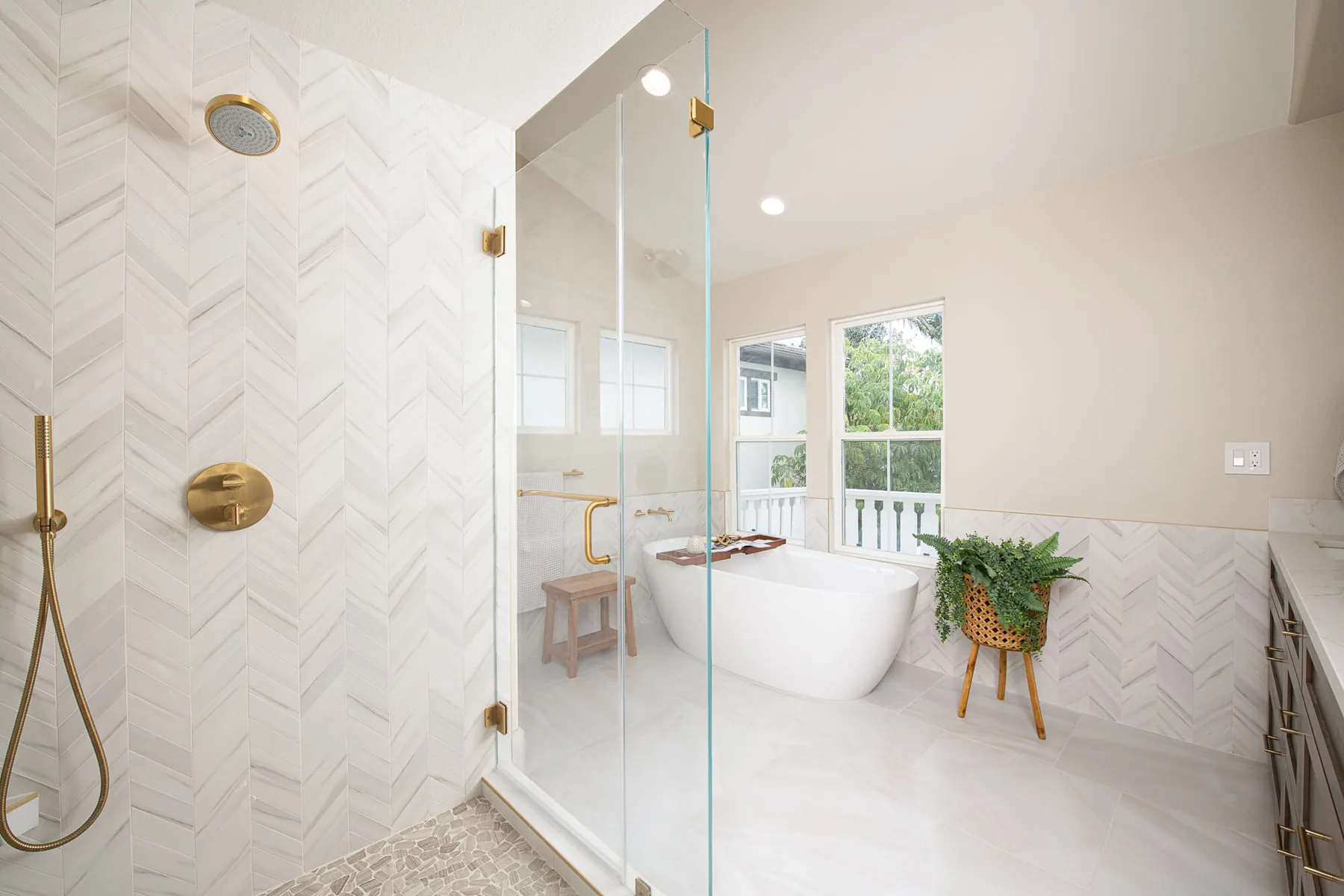 Marble walk-in shower and freestanding tub in a renovated primary bathroom in Loganville, GA