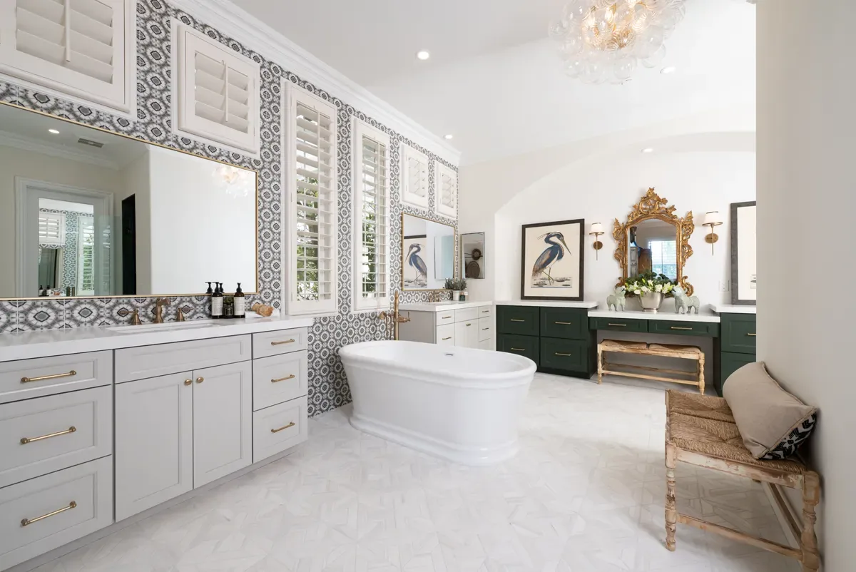 Wide primary bathroom with a freestanding tub, patterned tile walls and green vanity in Gwinnett County, GA