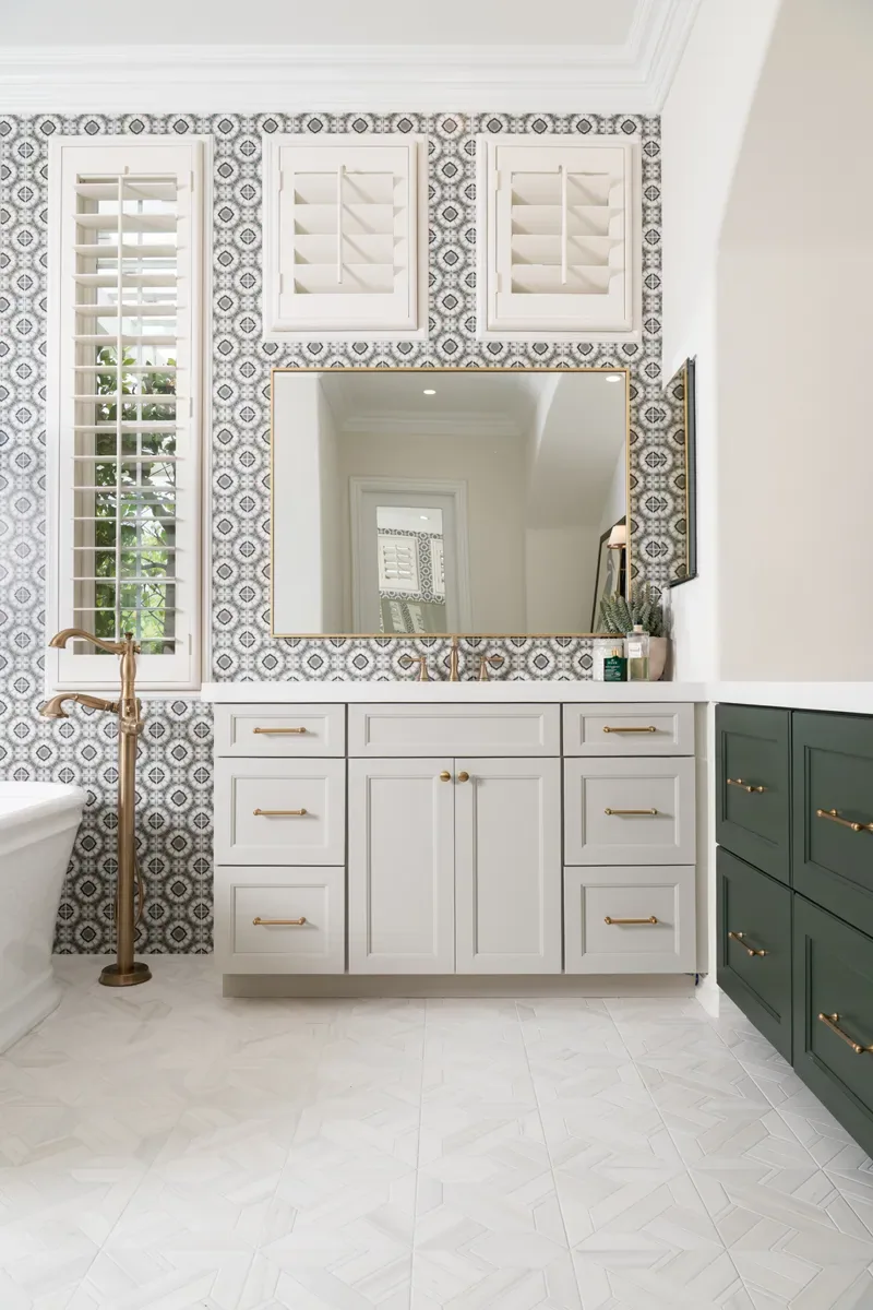 Patterned wall tile framing a vanity and green cabinetry in a Lawrenceville, GA bathroom remodel