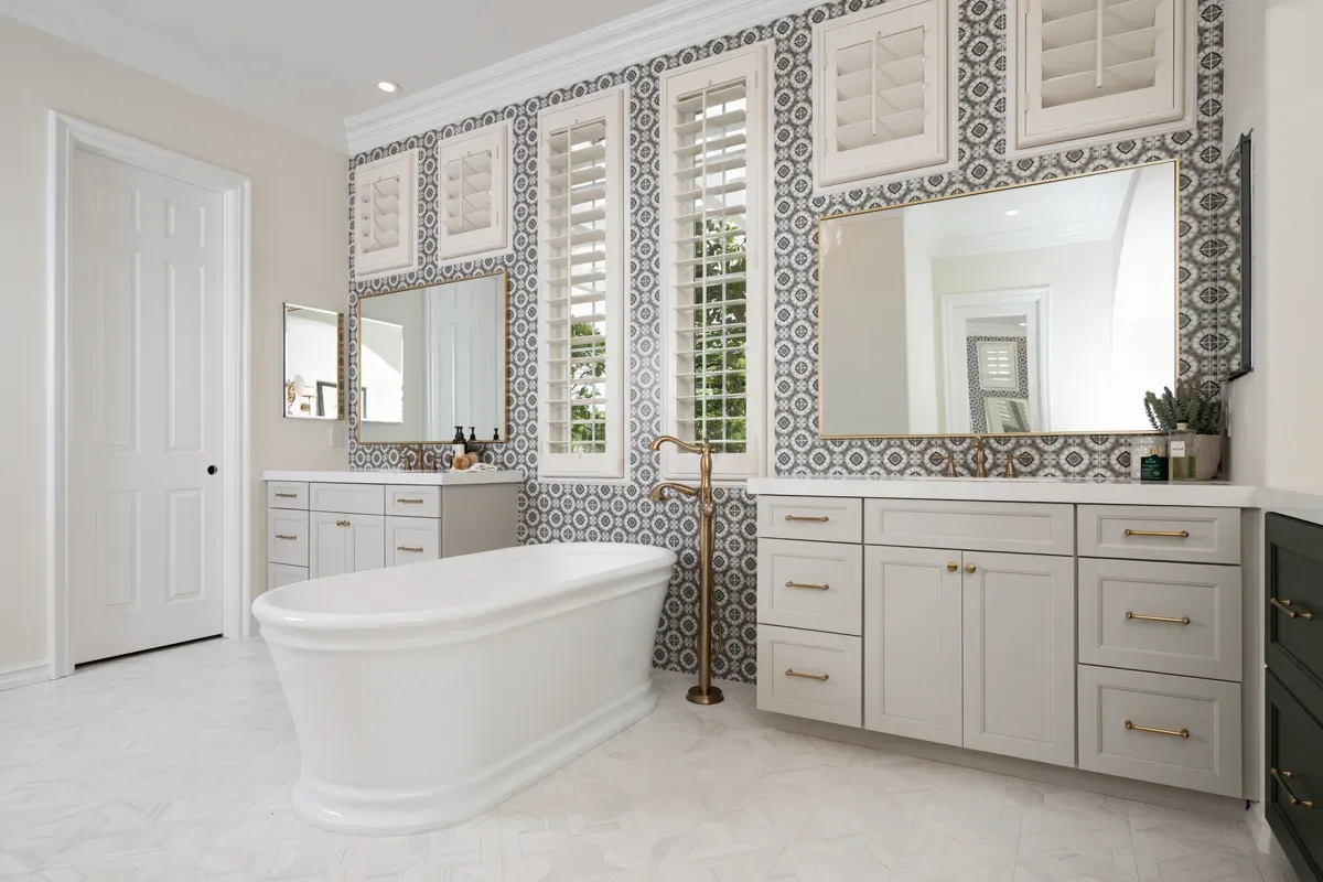 Freestanding tub and vanity against patterned tile in a finished Dacula, GA primary bathroom