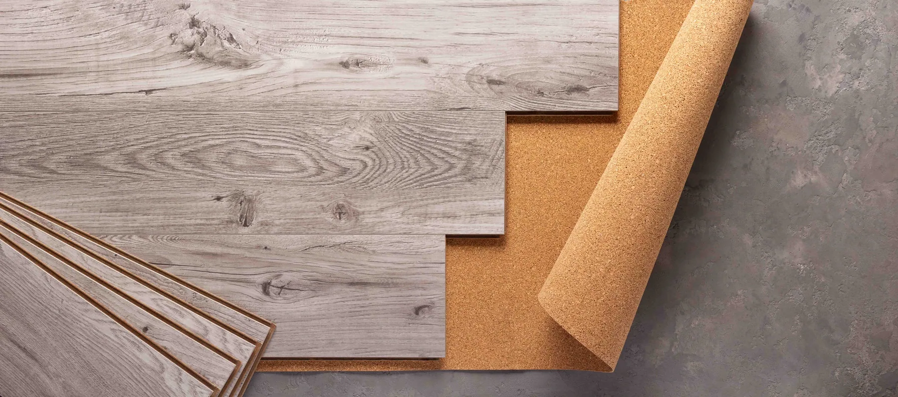 Flooring samples showing plank layers and cork underlayment used on Gwinnett County, GA installations