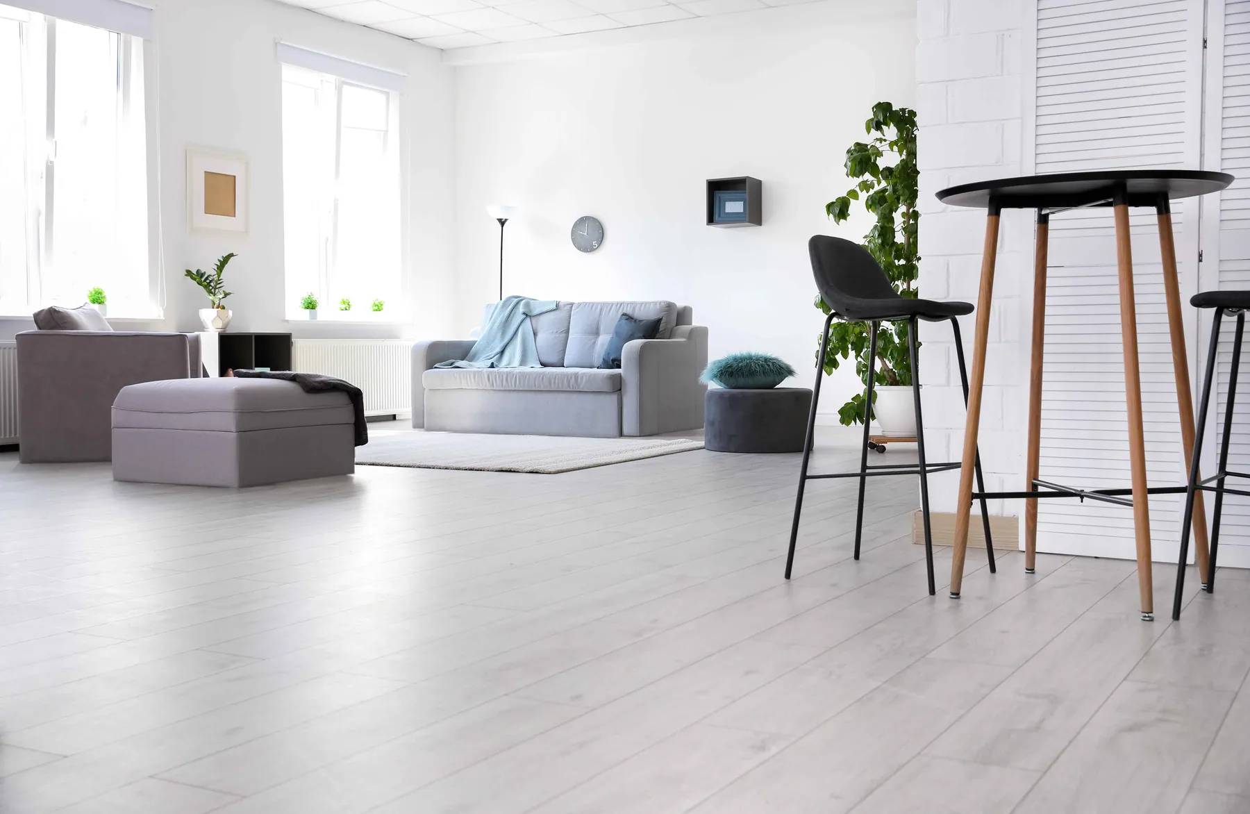Light wide-plank flooring running through a bright open living space near Loganville, GA