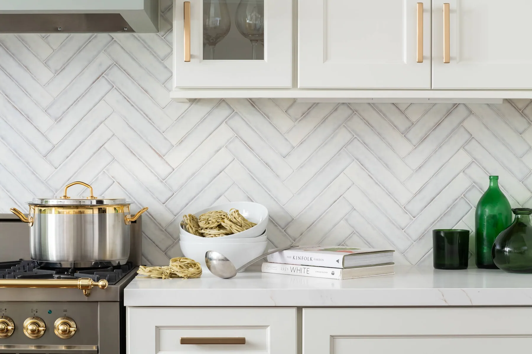 Herringbone marble backsplash meeting a quartz countertop in a Loganville, GA kitchen remodel