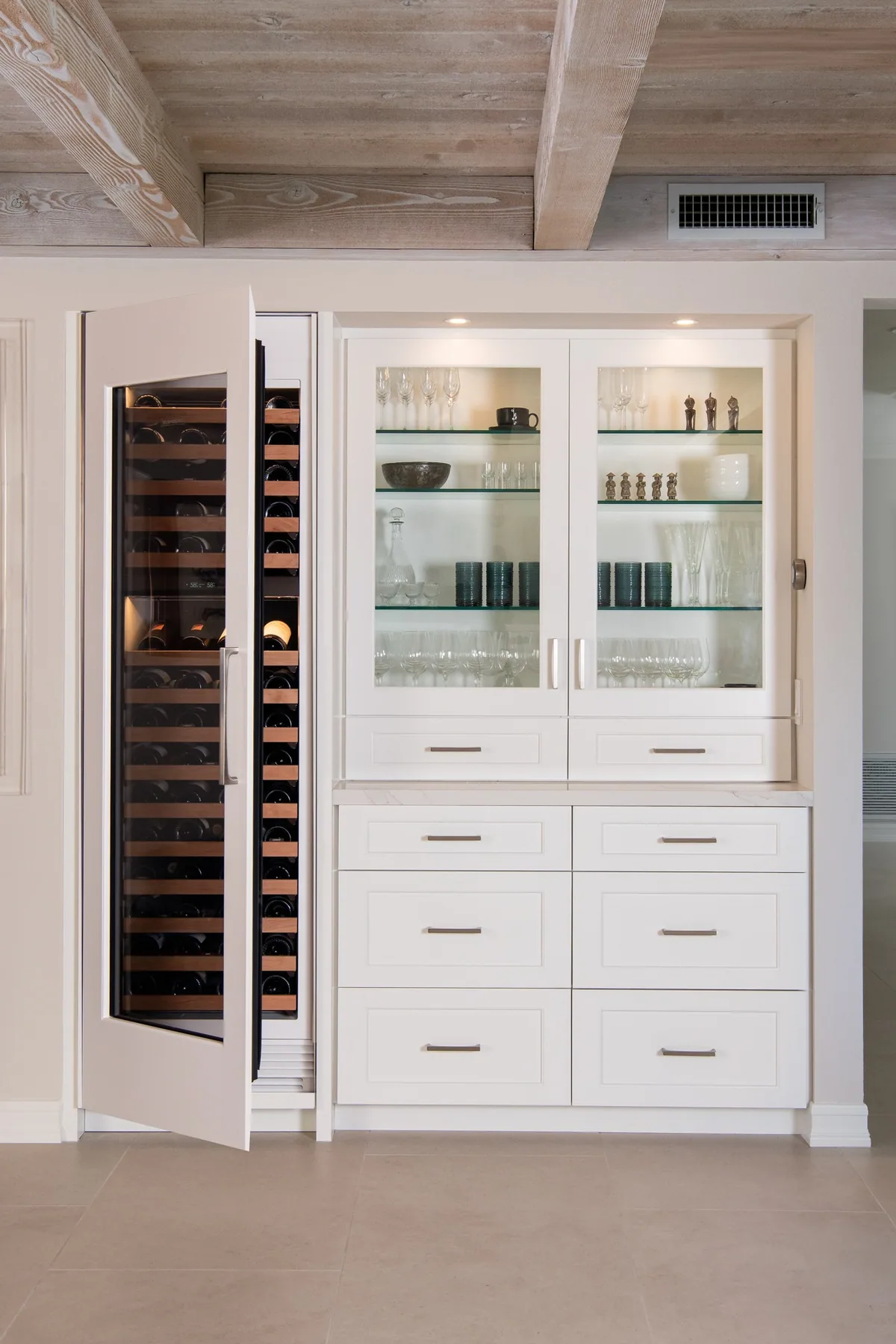 Built-in wine refrigerator and glass display cabinetry millwork in a Suwanee, GA home