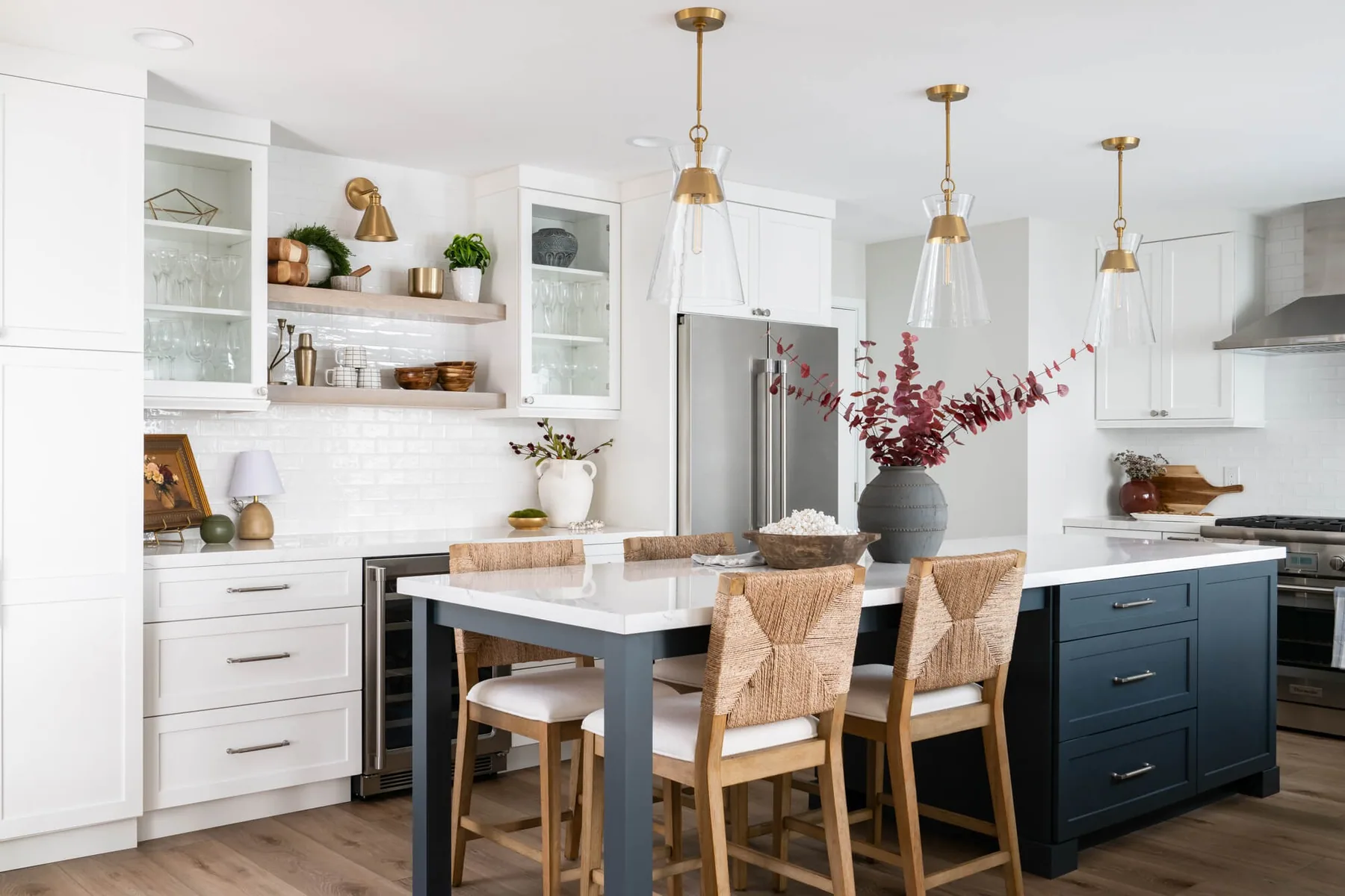 White and navy kitchen with floating shelves and a dining-height island in Snellville, GA