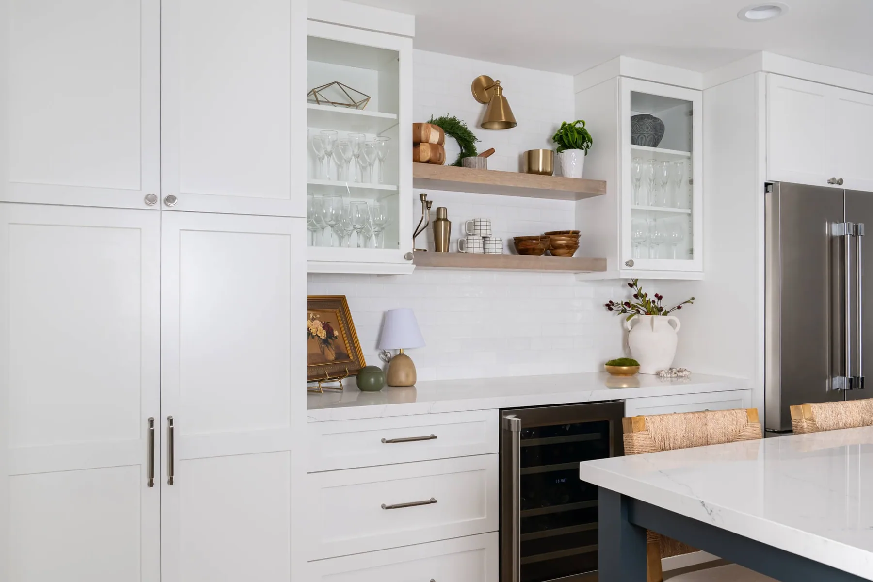 Tall pantry cabinetry, floating oak shelves and wine storage in a Sugar Hill, GA kitchen remodel
